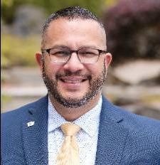 Man in a pink tie smiling