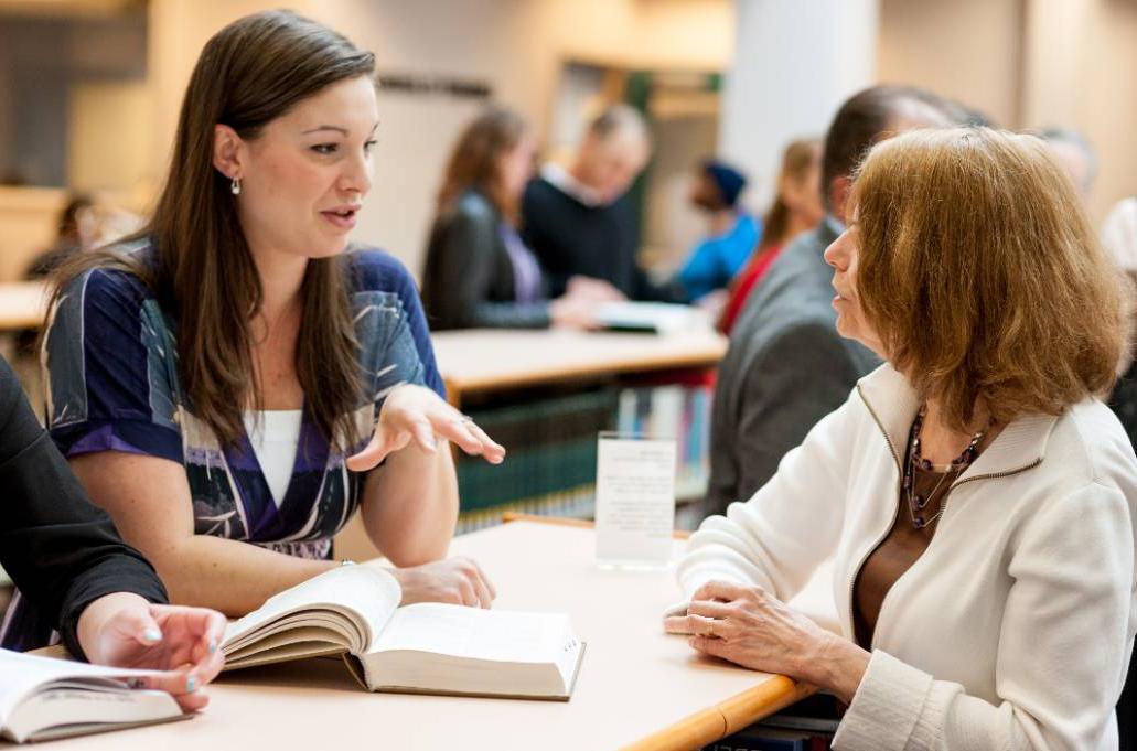 A student speaking to a faculty member at the library